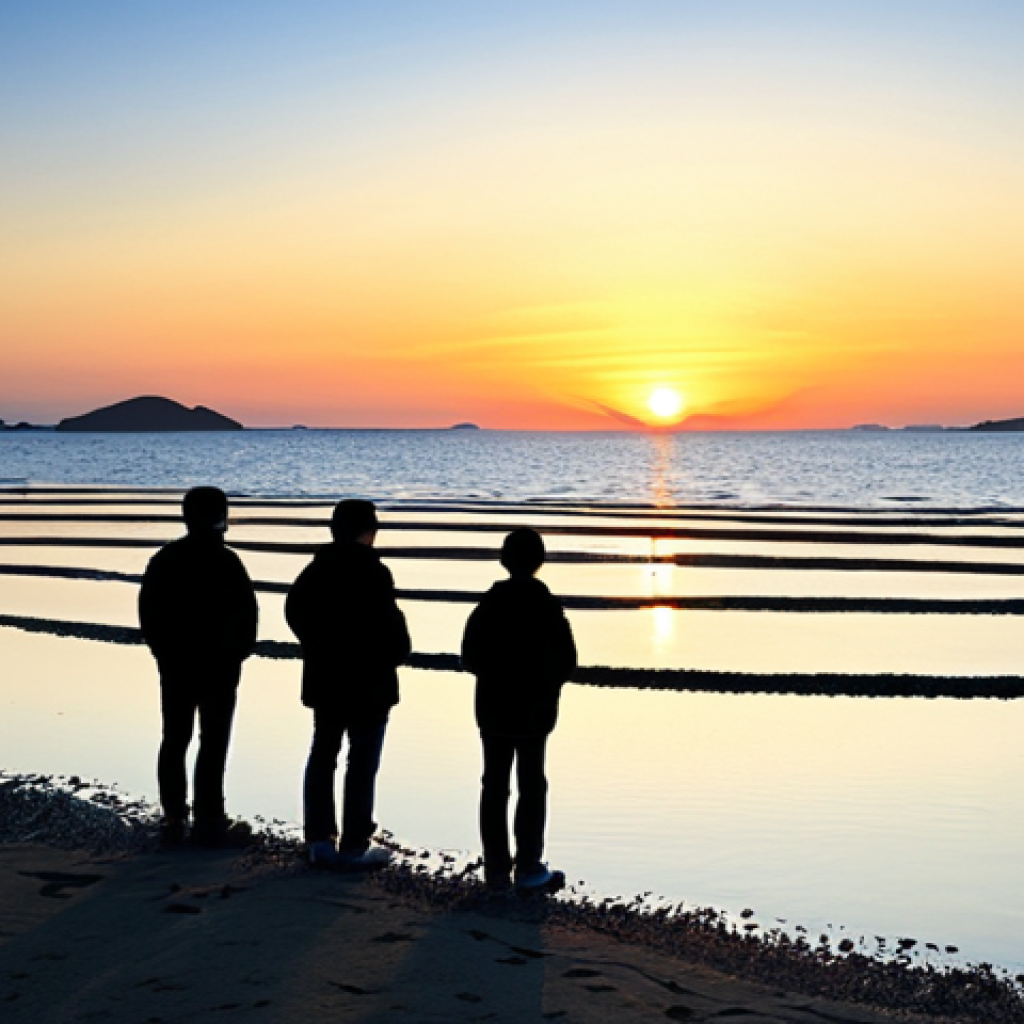 A wide-angle, professional photograph of Minmeoru Beach on Seokmodo Island during a spectacular sunset. The expansive tidal flats perfectly reflect the vibrant sky, which transitions from soft orange to deep crimson. Several individuals and small groups, fully clothed in modest, comfortable attire, stand peacefully observing the dramatic scene, their figures appearing as artistic silhouettes against the brilliant backdrop. The calm water gently laps the shore, adding to the serene atmosphere. Perfect anatomy, correct proportions, natural pose, well-formed hands, proper finger count. Safe for work, appropriate content, family-friendly.